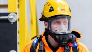 Worker in full face breathing apparatus