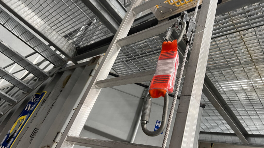 Vertical line shuttle with shock pack hanging off a ladder line installed on a fixed internal ladder.