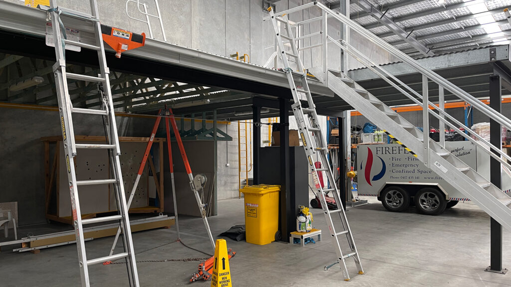Portable ladders attached to ladder brackets in the HSE Sydney training area