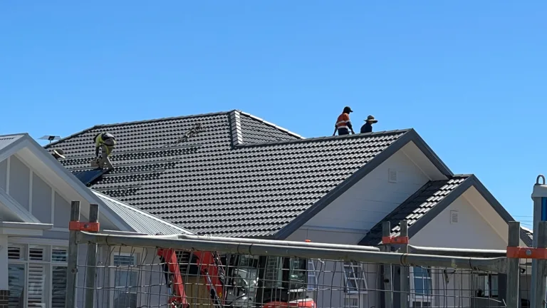 Workers exposing themselves to risk working on the roof of a new house.