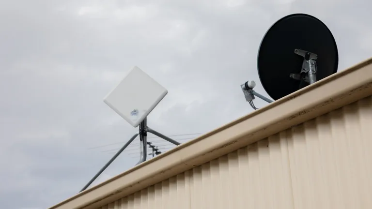 NBN receiver, satellite receiver and TV aerial on a single-storey dwelling's roof.