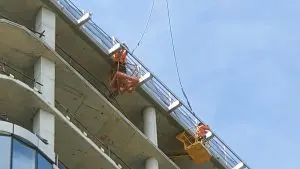 HSE installers installing Sayfa RAPTOR rail onto the roof of the Adina Pentridge Apartment building during construction.