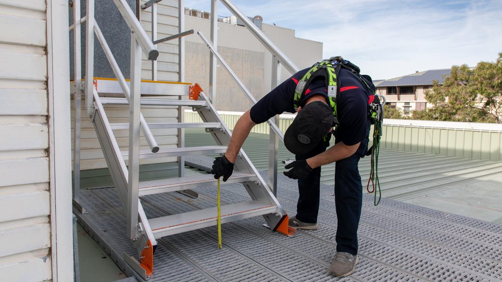 HSE technician inspecting an installed system to ensure it meets Australian standards.