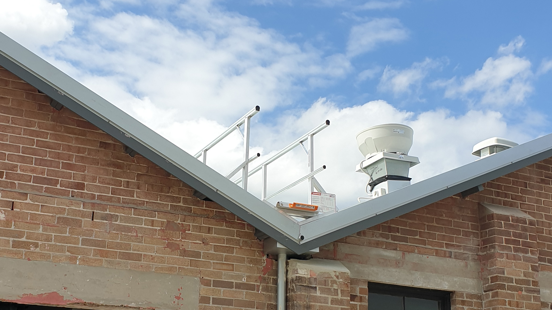 Safe access system comprising of a ladder bracket and guardrail.