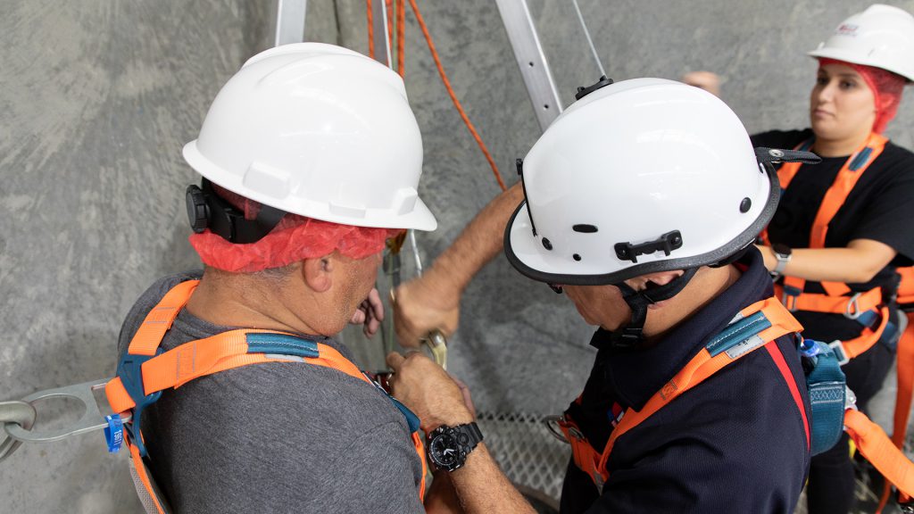 Course participant preparing to be lowered into a confined space.