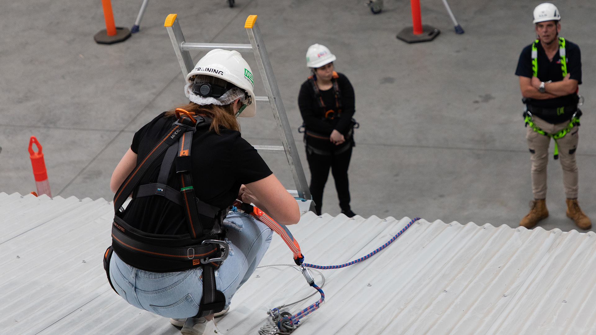 Course participant practising using a roof anchor system.