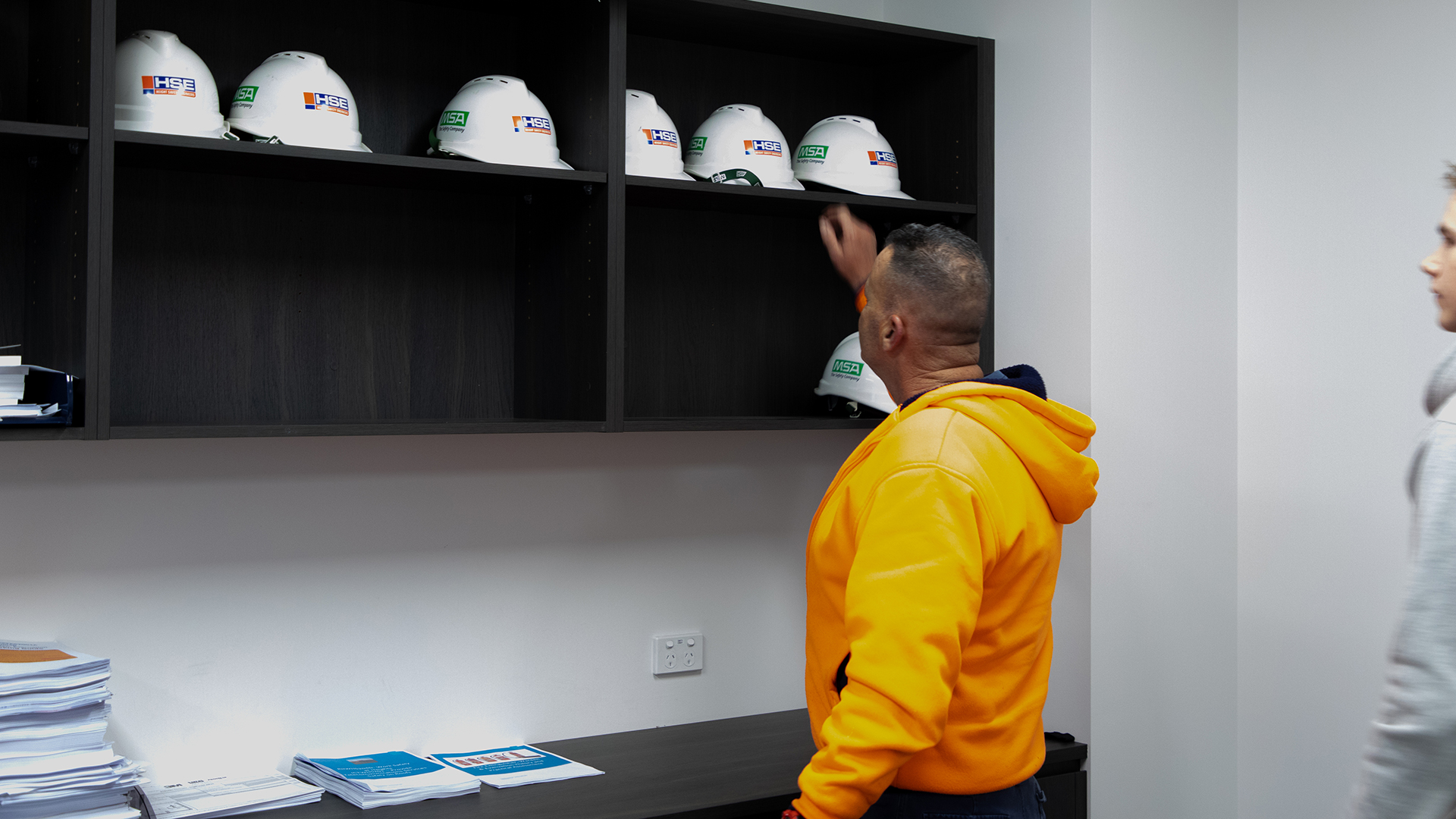 Course participant taking a hard hat off the classroom shelf.